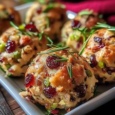 small appetizers with cranberries and herbs on a plate