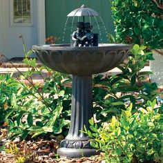 a bird bath in front of a house