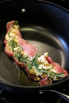 meat and vegetables cooking in a pan on the stove