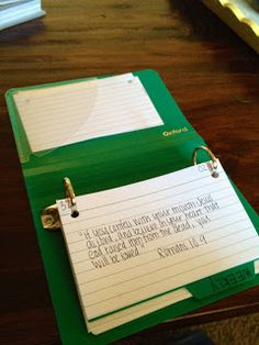 a green binder sitting on top of a wooden table