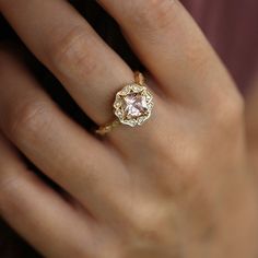 with an antique touch and a royal presence this ring is for a real princess. The center stone is a breathtaking morganite with a pinkish glow to it held by 8 magnificent claws. The stone is surrounded by 12 dazzling white diamonds set exquisitely in paisley like gold shapes. The band is waivy gold, dotted and encrusted with diamonds as well. This ring is just heart stopping from every angle. All features can be customized! please contact us if you wish to make changes, we love making custom designs. All of our jewelry is carefully handmade in our atelier *HC diamond are all conflict free diamonds To order by phone click here>> +972(0)722991000 Exquisite Formal Morganite Ring, Luxury Morganite Diamond Ring For Anniversary, Luxury Pink Gold Rings With Center Stone, Luxury Radiant Cut Topaz Wedding Ring, Luxury Pink Gold Ring With Center Stone, Luxury Morganite Diamond Wedding Ring, Elegant Morganite Ring With Center Stone, Elegant Morganite Diamond Ring With Gemstone, Formal Morganite Diamond Ring With Center Stone