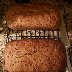 two loafs of bread sitting on top of a cooling rack