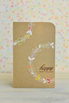 a card with the letter c on it and colorful leaves around it that says happy birthday