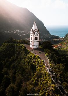 an aerial view of a steeple with a clock on the side and stairs leading up to it