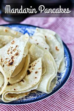 there is a blue and white plate with tortillas on it that says mandarin pancakes