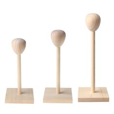 three wooden pegs with different shapes and sizes