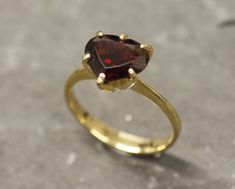 Gold Garnet Ring set with a Natural Garnet in a perfect diamond cut & a deep red color, from Mozambique, at 10x8mm, 3.5 Carats. Promise Ring design made of Gold Vermeil ☞ thickest 18k Gold Plating on top of Solid 925 Sterling Silver ☞ made to last. ☞ Choose your size ☞ I resize (before shipping) for FREE to Any size* Matching Earrings & Matching Pendant - please ask me January Birthstone - Genuine & Natural Stones ❀ ⌛Last Ring left ⌛ ❀ Each Natural Gem is unique & will have Slight variations fro Red Heart Ring, Heart Ring Gold, Heart Solitaire Ring, Gold Garnet Ring, Garnet Ring Vintage, Garnet Heart, Gold Heart Ring, Etsy Gold Ring, January Birthstone