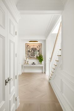 the hallway is clean and ready for guests to use it as an entrance way in this home