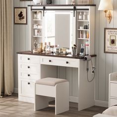 a bedroom with a vanity, mirror and stool