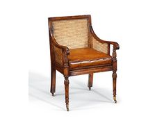 an old chair with wicker back and arm rests against a white background in the foreground