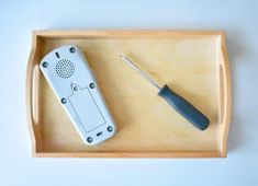 a remote control sitting on top of a wooden tray