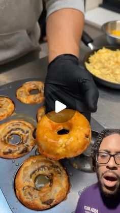 a man in black gloves is making donuts