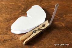 a pair of scissors sitting on top of a piece of paper next to a cut out heart