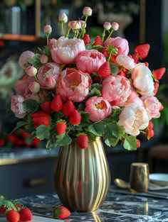 a vase filled with lots of pink flowers and strawberries on top of a table