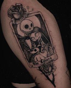 a tattoo on the arm of a woman with a skull and rose in it's frame