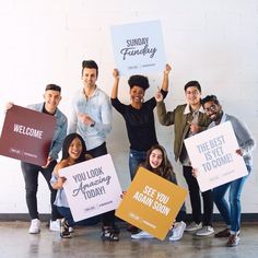 a group of people holding up signs in front of a white wall with the words, you look amazing today