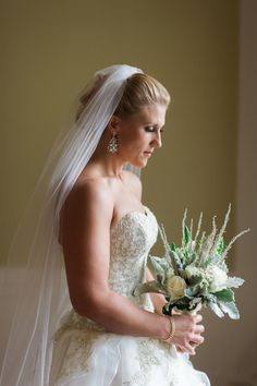 a woman in a wedding dress holding a bouquet