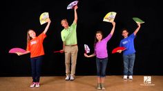 four children are holding up their handmade frisbees