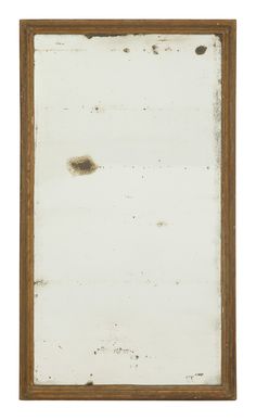 an old wooden frame with some brown paint on the bottom and white paper underneath it