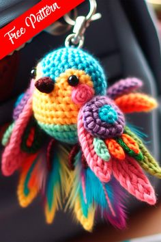 a colorful crocheted bird keychain hanging from a bag with the words free pattern on it