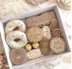 a box filled with lots of different types of cookies and pastries on top of a table