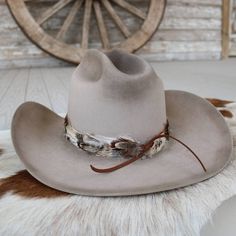 The Willow Western Feather Hat Band features a 3 cm width and an approximate length of 58 cm, excluding the leather ties. Designed to fit most sizes, this hat band is easily adjustable with leather ties, ensuring a comfortable and secure fit. The feather detailing adds a graceful, rustic touch, making it an ideal accessory for those who appreciate subtle western-inspired elegance. Adjustable Fedora For Western-themed Events, Adjustable Hat Bands For Country Events In Fall, Adjustable Country Hat Bands For Fall, Adjustable Fur Felt Hat For Kentucky Derby, Adjustable Western Hat Bands For Fall, Western Style Adjustable Top Hat For Outdoors, Adjustable Felt Hat With Flat Crown For Outdoor, Rustic Adjustable Brimmed Top Hat, Adjustable Wide Brim Top Hat For Ranch