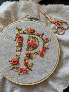 a close up of a embroidery on a table with scissors