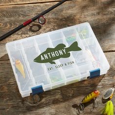 an assortment of fishing lures and tackle boxes on a wooden table with the name anthony eat sleep fish