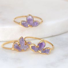 Buy any 3 items, get 20% off! (Note: Coupons cannot stack) A simple amehtyst ring with a comfortable dainty ring shank. Stacks well with other colored gemstone rings. Amethyst are the birthstone for February! However, these gems are super trendy and can be worn by anyone who loves purple and gold. ✨ Natural, uncut Amethyst Gem size – 3-5mm 14k Gold Fill Shank 24k Gold Dipped ✨ The ring shank is made entirely with 14k gold filled wire, which has been plated with 24k gold for more intense color. U Amethyst Adjustable Stackable Rings As A Gift, Adjustable Amethyst Stackable Rings As Gift, Delicate Amethyst Ring As Gift, Adjustable Amethyst Stackable Rings, Amethyst Stackable Rings As Gift, Dainty Amethyst Gemstone Stackable Rings, Dainty Amethyst Stackable Rings For Gift, Dainty Stackable Amethyst Ring Gift, Dainty Stackable Amethyst Ring As A Gift