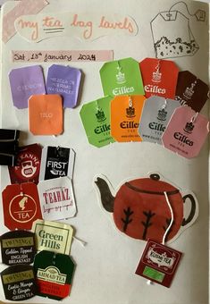 an assortment of tea bags and labels on a white board