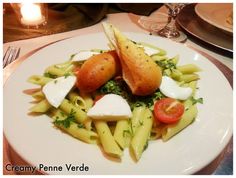 a white plate topped with pasta and veggies