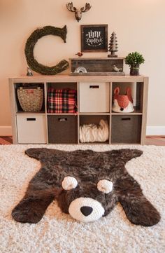 a bear rug is on the floor in front of a shelf with other items and decorations