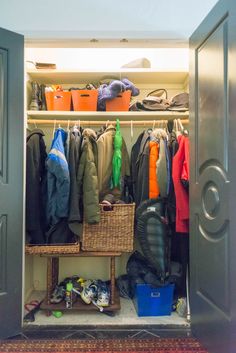 an open closet filled with clothes and other items