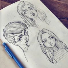 three drawings of people's faces on paper with a blue pen next to them