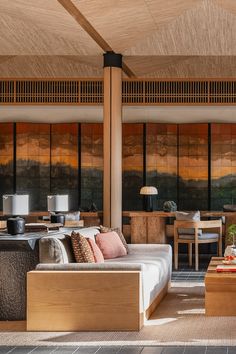 a living room filled with furniture next to a wooden ceiling covered in wood paneling