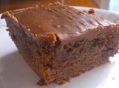 a piece of chocolate cake sitting on top of a white plate