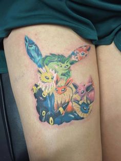 a woman's thigh with pokemon tattoos on it