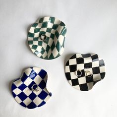 three checkered plates are shown on a white surface