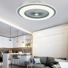 a living room filled with furniture next to a kitchen