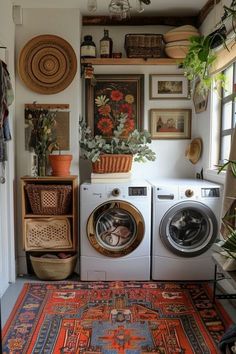 a washer and dryer in a room with pictures on the wall above it