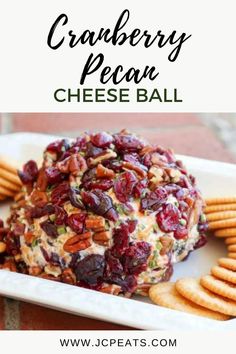 cranberry pecan cheese ball on a white plate with crackers around it