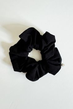 Experience the soft touch and feel of nature with our Black Sands Tencel Scrunchie. Made from eco-friendly black Tencel Lyocell Organic Cotton Spandex Jersey fabric and elastic crafted with Organic Cotton Natural Rubber, this scrunchie is a sustainable alternative to silk. Perfect for slow moments at the beach. Tencel fabric Engraved COUTONIC bronze label Hand wash and line dry flat Designed and handmade in Orlando, Florida, USA HOW IT’S MADE Our ethically crafted scrunchies are made with a soft, luxurious dead-stock Tercel fabric and elastic crafted with Organic Cotton Natural Rubber. Crafted with care, our scrunchies are adorned with dainty bronze COUTONIC branded labels, each meticulously fashioned by a skilled craftsman with whom we maintain a direct and collaborative partnership. Thes Slow Moments, Tencel Fabric, Light Blue Shorts, Slow Fashion Brands, Florida Usa, Black Sand, Orlando Florida, Natural Rubber, Jewelry Bags