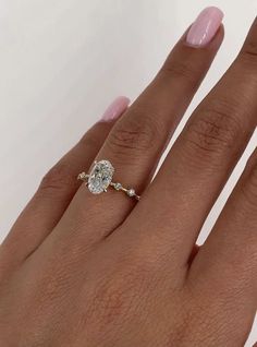 a woman's hand with a diamond ring on it