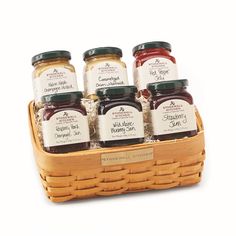 six jars of jam in a wicker basket