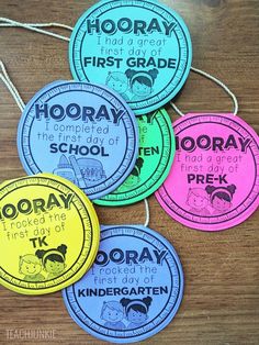 four circular stickers that say hooray first day of school