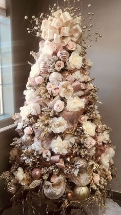 the christmas tree is decorated with flowers and ornaments