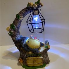 a lamp that is sitting on top of a tree stump with a bird in it