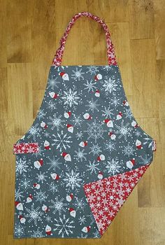 an apron is sitting on the floor with snowflakes