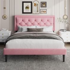 a bed with pink upholstered headboard in a white and gray bedroom setting