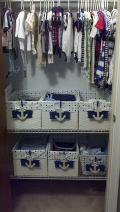 an organized closet with baskets and clothes hanging on the wall, along with baby's clothing